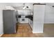 Open kitchen layout featuring updated appliances, white cabinets, and tile flooring at 10344 Rosemount Dr, Tampa, FL 33624