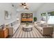 Bright living room with neutral paint, ceiling fan, and lots of natural light. Bookcase included at 10344 Rosemount Dr, Tampa, FL 33624