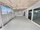 This covered patio offers ample space for outdoor living and entertaining with a bright white fence at 10344 Rosemount Dr, Tampa, FL 33624