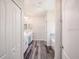 Hallway view of bathroom with dual vanity, tub, and tiled shower at 11126 Jenny Wren Rd, Weeki Wachee, FL 34614