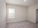 Comfortable bedroom with neutral carpet and a large window offering natural light at 11126 Jenny Wren Rd, Weeki Wachee, FL 34614