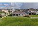 Back view of a single-Gathering home with a sodded yard at 11818 Tetrafin Dr, Riverview, FL 33579