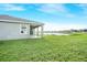 View of the backyard featuring a covered patio and a serene lake view at 11818 Tetrafin Dr, Riverview, FL 33579