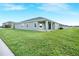 A single-story home with a backyard that is fully sodded at 11818 Tetrafin Dr, Riverview, FL 33579