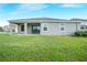 Backyard is flat, sodded, and adjacent to a single-story home at 11818 Tetrafin Dr, Riverview, FL 33579