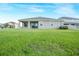 A lush green backyard is visible from the exterior of this home at 11818 Tetrafin Dr, Riverview, FL 33579