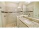 Contemporary primary bathroom offers a frameless glass shower with tile surround and a granite countertop vanity at 11818 Tetrafin Dr, Riverview, FL 33579