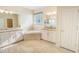 Elegant primary bathroom with double vanity, soaking tub, walk-in closet, and luxurious finishes at 11818 Tetrafin Dr, Riverview, FL 33579