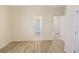 Bedroom with wood-look flooring and access to the bathroom and hallway at 11818 Tetrafin Dr, Riverview, FL 33579