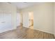 Bright bedroom featuring modern wood-look flooring and neutral paint at 11818 Tetrafin Dr, Riverview, FL 33579