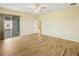 This spacious bedroom boasts wood-look tile flooring, a ceiling fan, and a sliding glass door to the backyard at 11818 Tetrafin Dr, Riverview, FL 33579