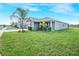 Beautiful single-story home with lush green lawn and landscaped garden at 11818 Tetrafin Dr, Riverview, FL 33579