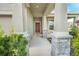 Inviting covered front porch with stone accents and manicured landscaping at 11818 Tetrafin Dr, Riverview, FL 33579