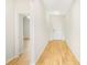 Hallway featuring wood-look flooring with door leading outside and to other rooms at 11818 Tetrafin Dr, Riverview, FL 33579