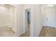 Hallway view of a full bathroom, a doorway to a bedroom, and the front door at 11818 Tetrafin Dr, Riverview, FL 33579