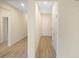 A naturally lit hallway featuring wood-look flooring that leads to a door at 11818 Tetrafin Dr, Riverview, FL 33579