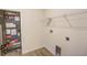 A utility closet and an air handler stand next to laundry connections with wire rack shelving overhead at 11818 Tetrafin Dr, Riverview, FL 33579