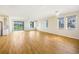 Bright living room boasts wood-look tile flooring, recessed lights, chandeliers, and large windows allowing ample natural light at 11818 Tetrafin Dr, Riverview, FL 33579