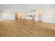 Expansive living room with wood-look tile flooring seamlessly connects to the modern kitchen, perfect for entertaining at 11818 Tetrafin Dr, Riverview, FL 33579