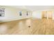 Open living room with wood-look tile flooring, recessed lights, and large windows offers a spacious and inviting atmosphere at 11818 Tetrafin Dr, Riverview, FL 33579