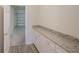 Mud room with granite counters, white cabinets, and door to garage at 11818 Tetrafin Dr, Riverview, FL 33579
