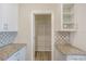 Pantry features tiled backsplash, granite countertops and wire shelving at 11818 Tetrafin Dr, Riverview, FL 33579
