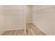 Spacious walk-in closet with ample shelving and wood-look tile flooring, providing organized storage space at 11818 Tetrafin Dr, Riverview, FL 33579