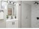 Bathroom featuring marble tiled walk-in shower and a vanity with black hardware at 709 1St Ne Ave, Largo, FL 33770
