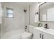 Bathroom featuring a shower and tub, black hardware, and tiled walls at 709 1St Ne Ave, Largo, FL 33770