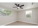 Bedroom featuring updated flooring, a ceiling fan, and two bright windows at 709 1St Ne Ave, Largo, FL 33770