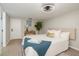 Bedroom features a tray with a book on the bed, and a stylish ceiling fan at 709 1St Ne Ave, Largo, FL 33770