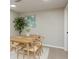 Bright dining room featuring a table set for four, a decorative plant, and a sunlit window at 709 1St Ne Ave, Largo, FL 33770