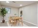 Bright dining room featuring a table set for four, a decorative plant, and a sunlit window at 709 1St Ne Ave, Largo, FL 33770