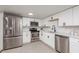 Modern kitchen with stainless steel appliances, white cabinets, and subway tile backsplash at 709 1St Ne Ave, Largo, FL 33770
