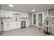 Modern kitchen featuring white cabinets, stainless steel appliances, and natural light at 709 1St Ne Ave, Largo, FL 33770
