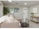 Well-lit living room with a large window and stylish console table at 709 1St Ne Ave, Largo, FL 33770
