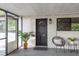 Cozy screened front porch with a decorative door and comfortable seating space at 709 1St Ne Ave, Largo, FL 33770