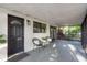 Inviting screened porch with comfortable seating, ideal for relaxing outdoors at 709 1St Ne Ave, Largo, FL 33770