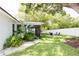 Spacious backyard with patio, fire pit, lush landscaping, and privacy fence at 3920 Basswood Dr, Sarasota, FL 34232