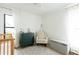 Well-lit Bedroom featuring a crib, dresser, chair, and patterned rug at 3920 Basswood Dr, Sarasota, FL 34232