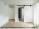 Minimalist bedroom with sliding barn door leading to a walk-in closet at 3920 Basswood Dr, Sarasota, FL 34232