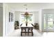 Bright dining room with modern lighting fixture and lots of natural light at 3920 Basswood Dr, Sarasota, FL 34232