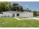Charming home featuring a minimalist design, a wide driveway, and a well-manicured lawn at 3920 Basswood Dr, Sarasota, FL 34232