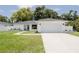 Charming home featuring a minimalist design, a wide driveway, and a well-manicured lawn at 3920 Basswood Dr, Sarasota, FL 34232