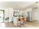Stylish kitchen featuring white cabinets, a center island with bar seating, and modern pendant lighting at 3920 Basswood Dr, Sarasota, FL 34232
