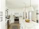 Clean kitchen with white cabinets, stainless steel appliances, and a marble-look countertop island at 3920 Basswood Dr, Sarasota, FL 34232