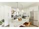 Bright kitchen with a center island, stainless steel appliances, and sleek white cabinetry at 3920 Basswood Dr, Sarasota, FL 34232