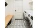 Laundry room with patterned tile floor, washer, and dryer at 3920 Basswood Dr, Sarasota, FL 34232