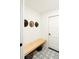 Mudroom with hats, bench, and patterned tile floor at 3920 Basswood Dr, Sarasota, FL 34232