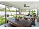 Covered patio with dining table, swing bench, and backyard view at 3920 Basswood Dr, Sarasota, FL 34232